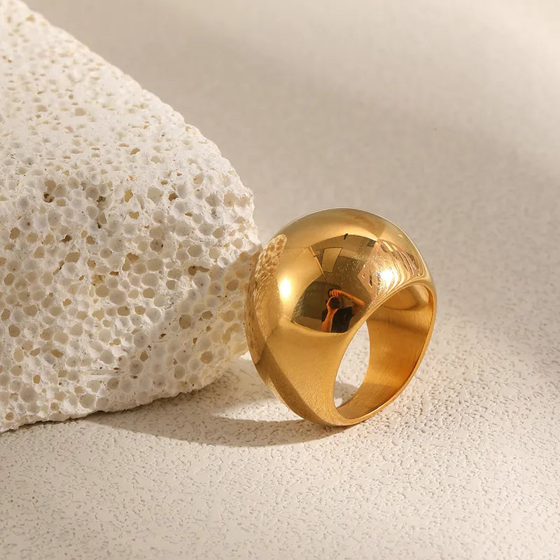 Close-up of gold dome ring beside driftwood – non-tarnish statement ring South Africa