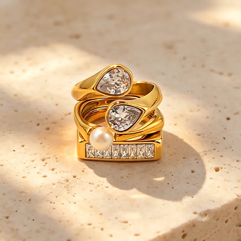 Ultra 3 Ring Stack Set gold rings with zircon and pearl stacked on stone surface South Africa