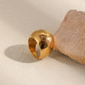Gold dome ring leaning against natural stone – waterproof titanium ring South Africa